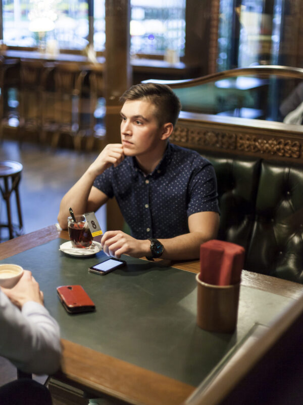 young-man-with-cup-tea-restaurant